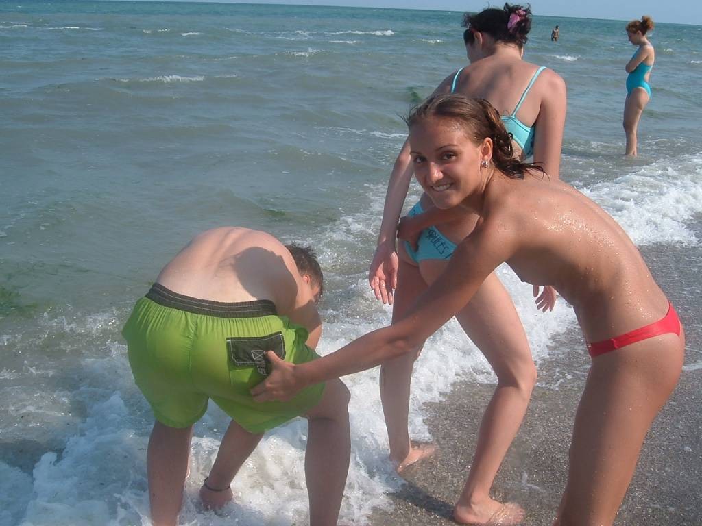 Blonde nudist strips down naked at a public seashore #72248607