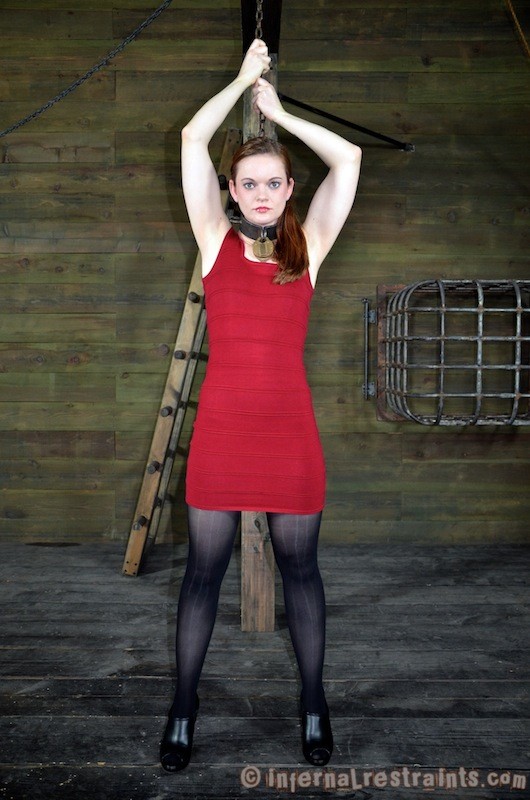 Hazel hypnotic in rotem Kleid wird in Ketten und Holzstöcken gefesselt
 #71980494