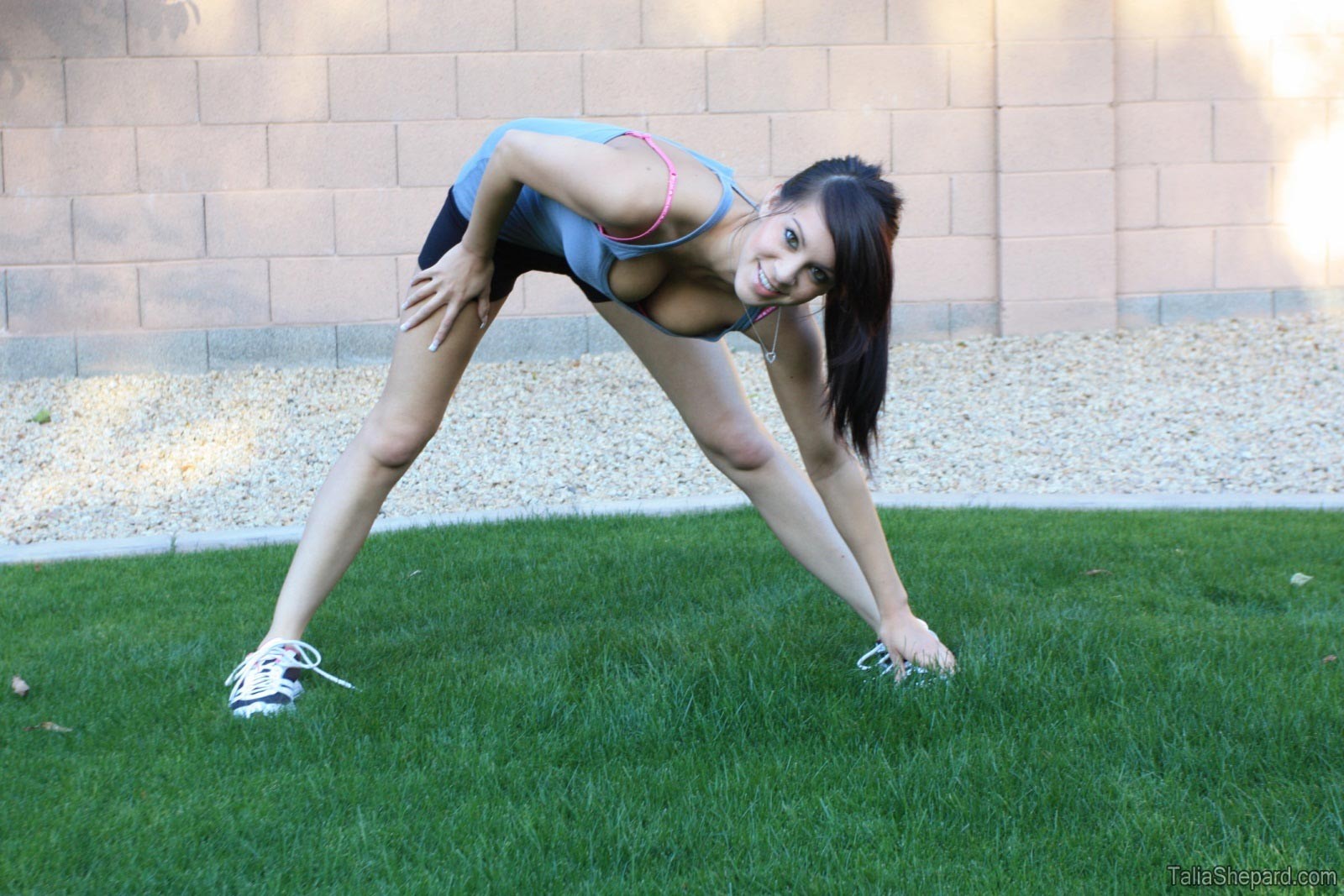 Hot brunette stretching outside #72559236