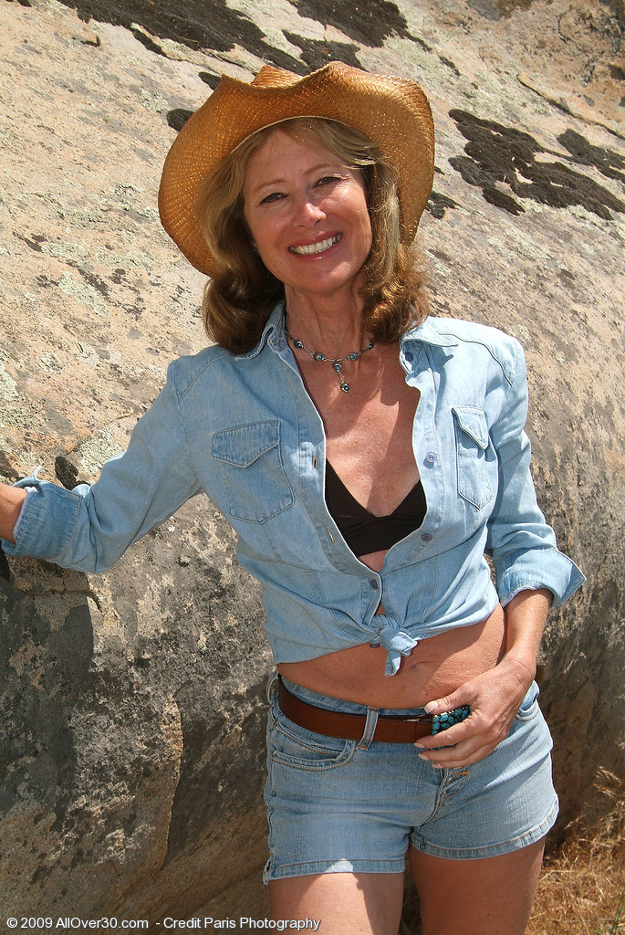 61 year old Janet L peels of her blue jeans and spreads on the rocks|Janet L0|De #77504874