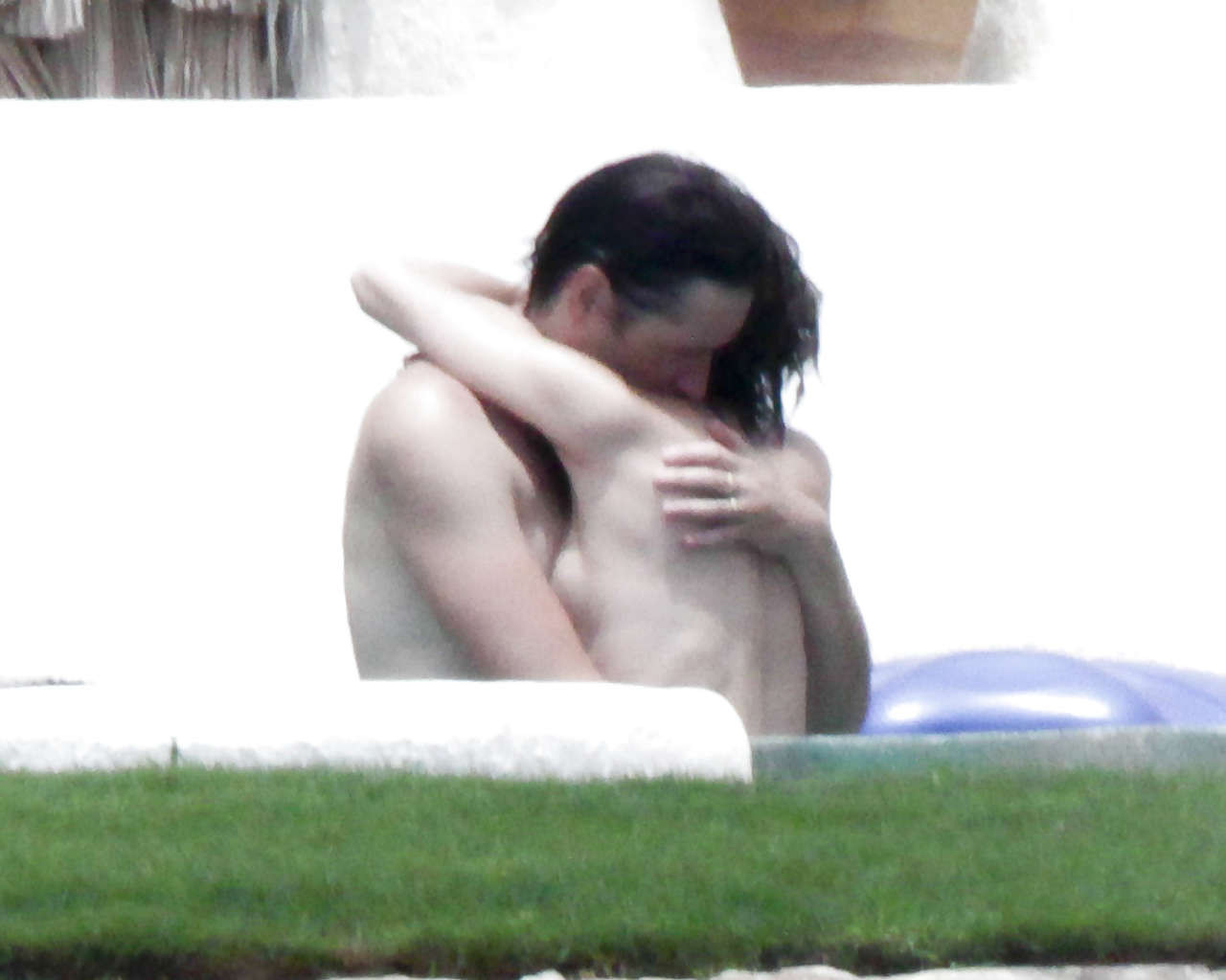 Milla Jovovich caught topless in pool by paparazzi and giving them middle finger #75289843