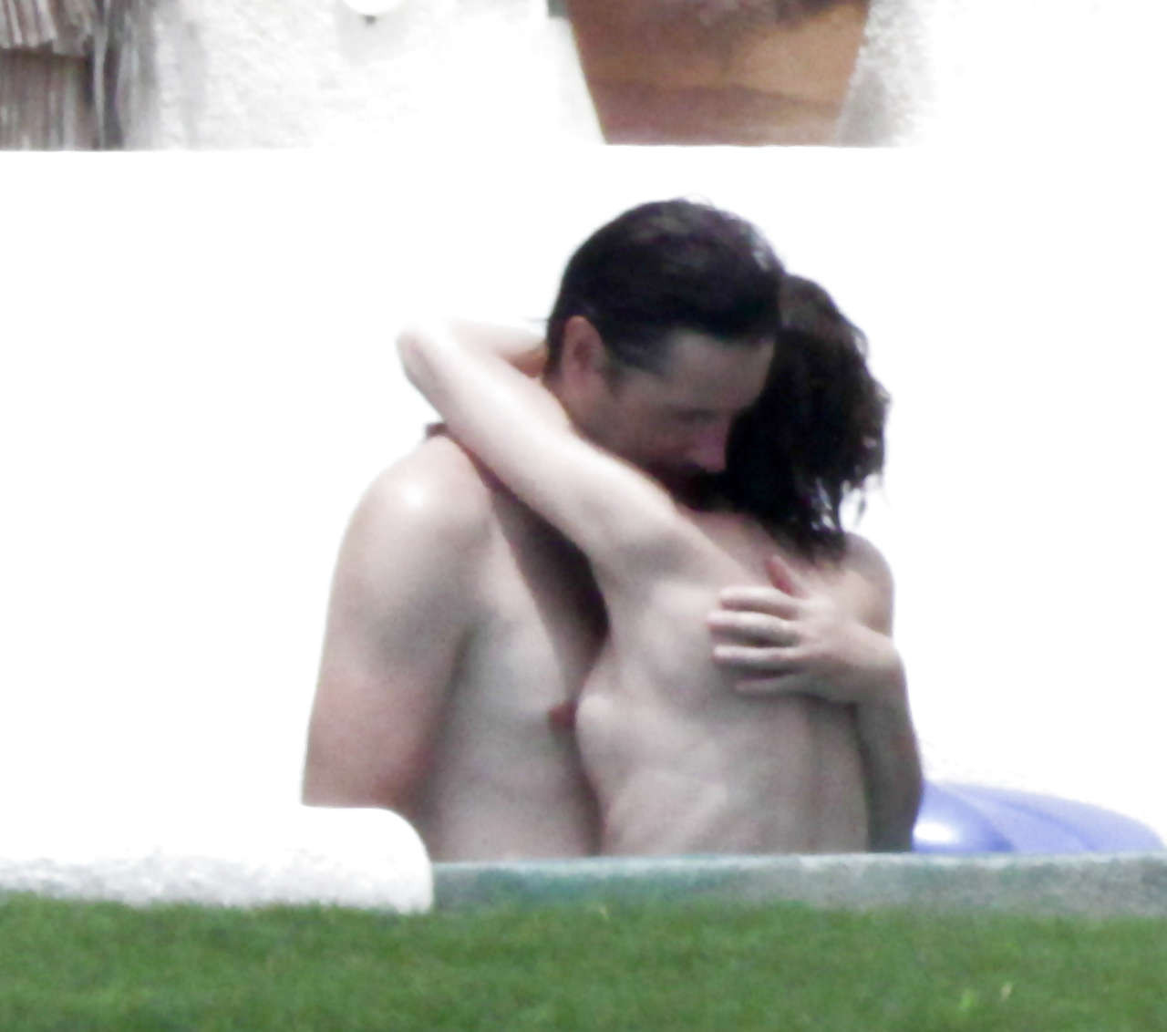 Milla Jovovich caught topless in pool by paparazzi and giving them middle finger #75289848