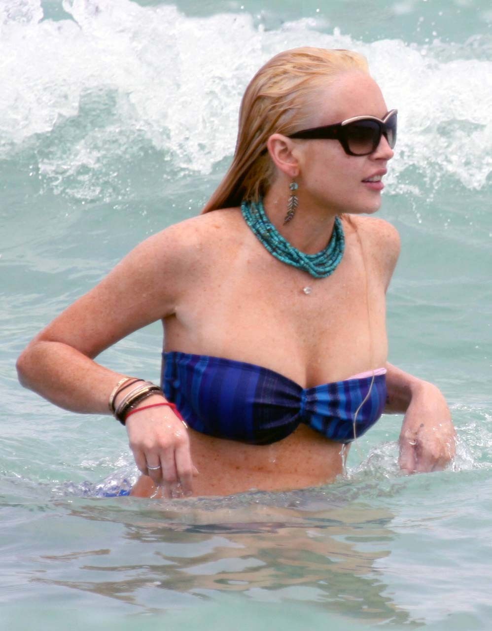 Lindsay Lohan tits slip from bikini on beach oops paparazzi pictures #75303541