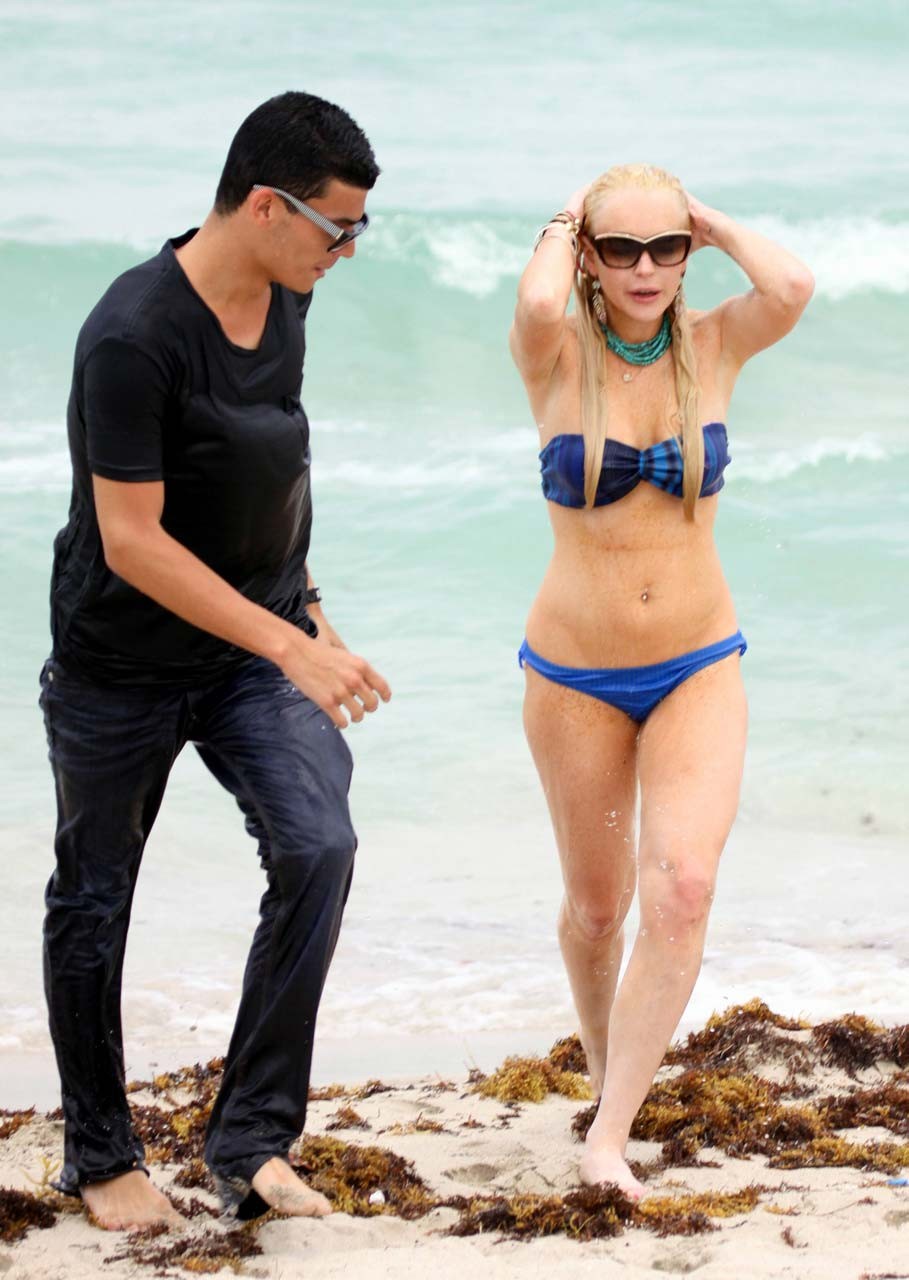 Lindsay Lohan tits slip from bikini on beach oops paparazzi pictures #75303567
