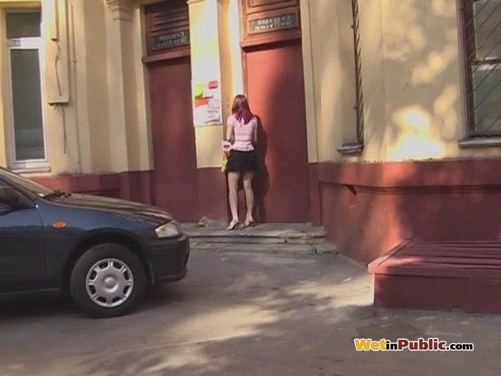 Gal does a pee in her black skirt as has found no toilet in the street #78595530