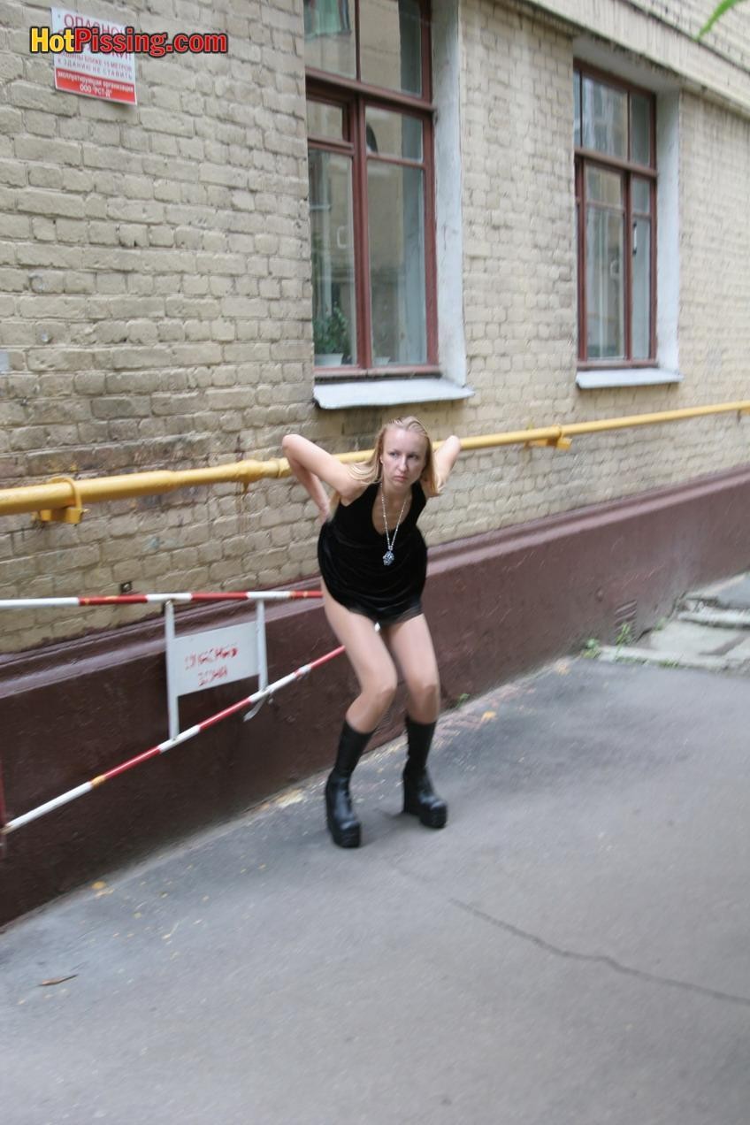 Gothic lady in black dress and platform boots does a pee in the street #76561219