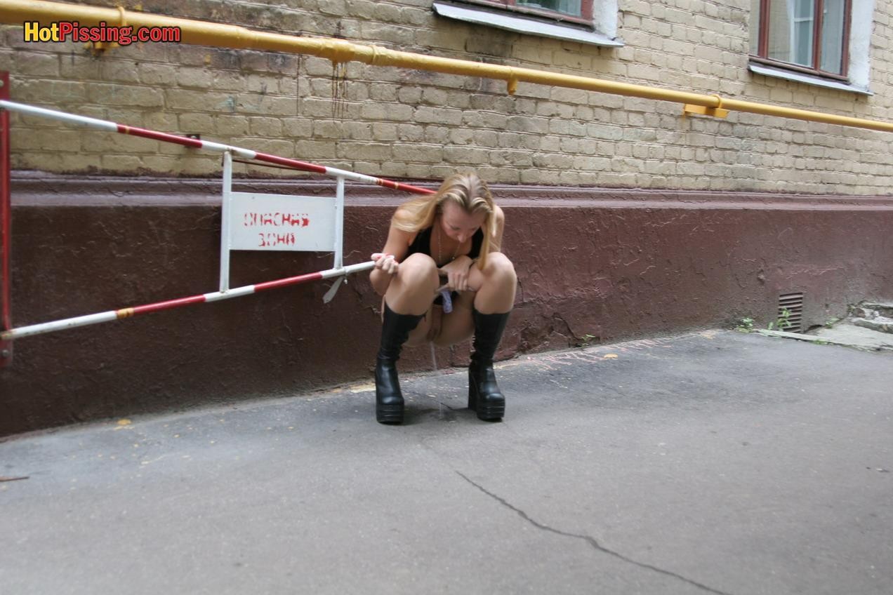 Gothic lady in black dress and platform boots does a pee in the street #76561239