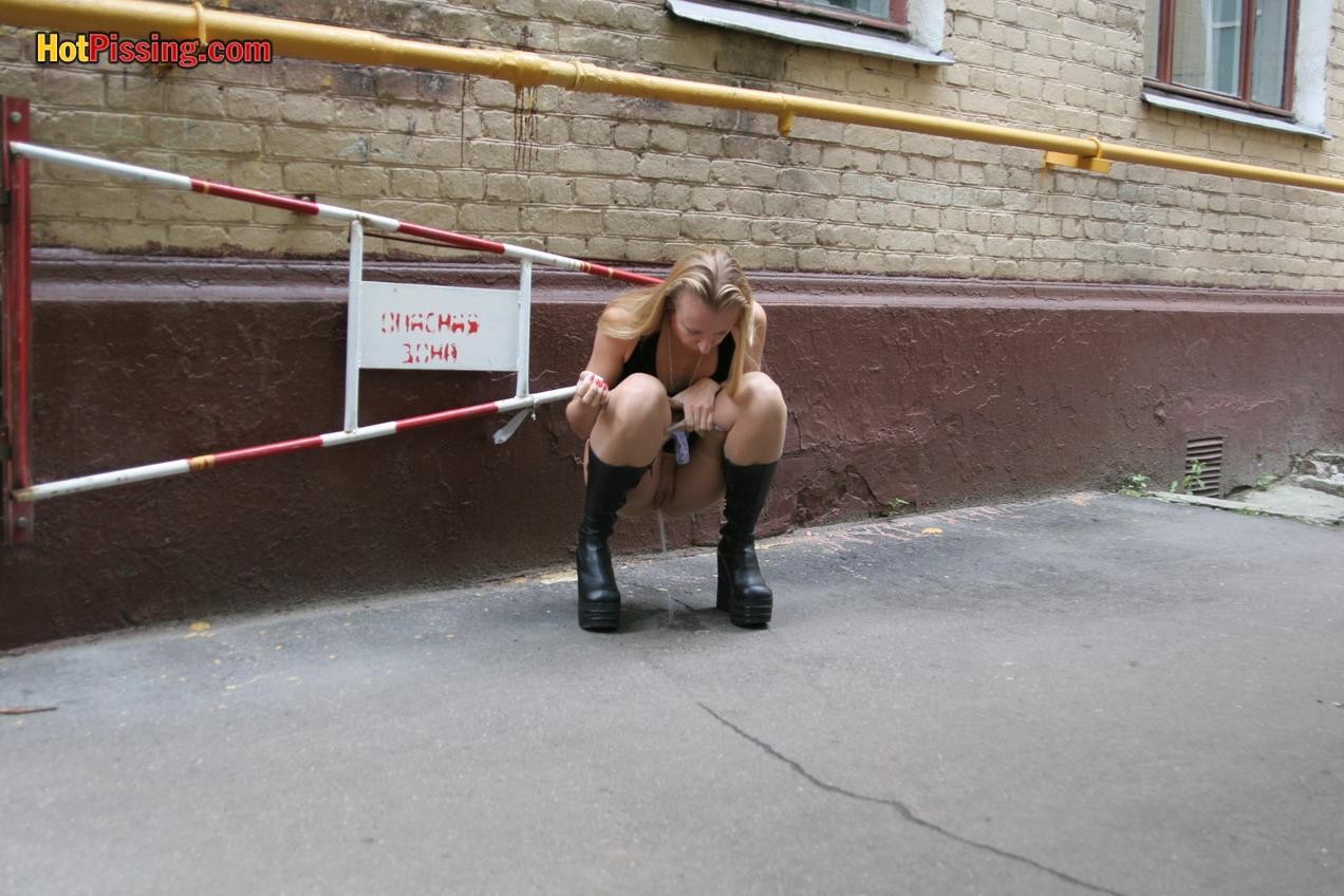 Gothic lady in black dress and platform boots does a pee in the street #76561266