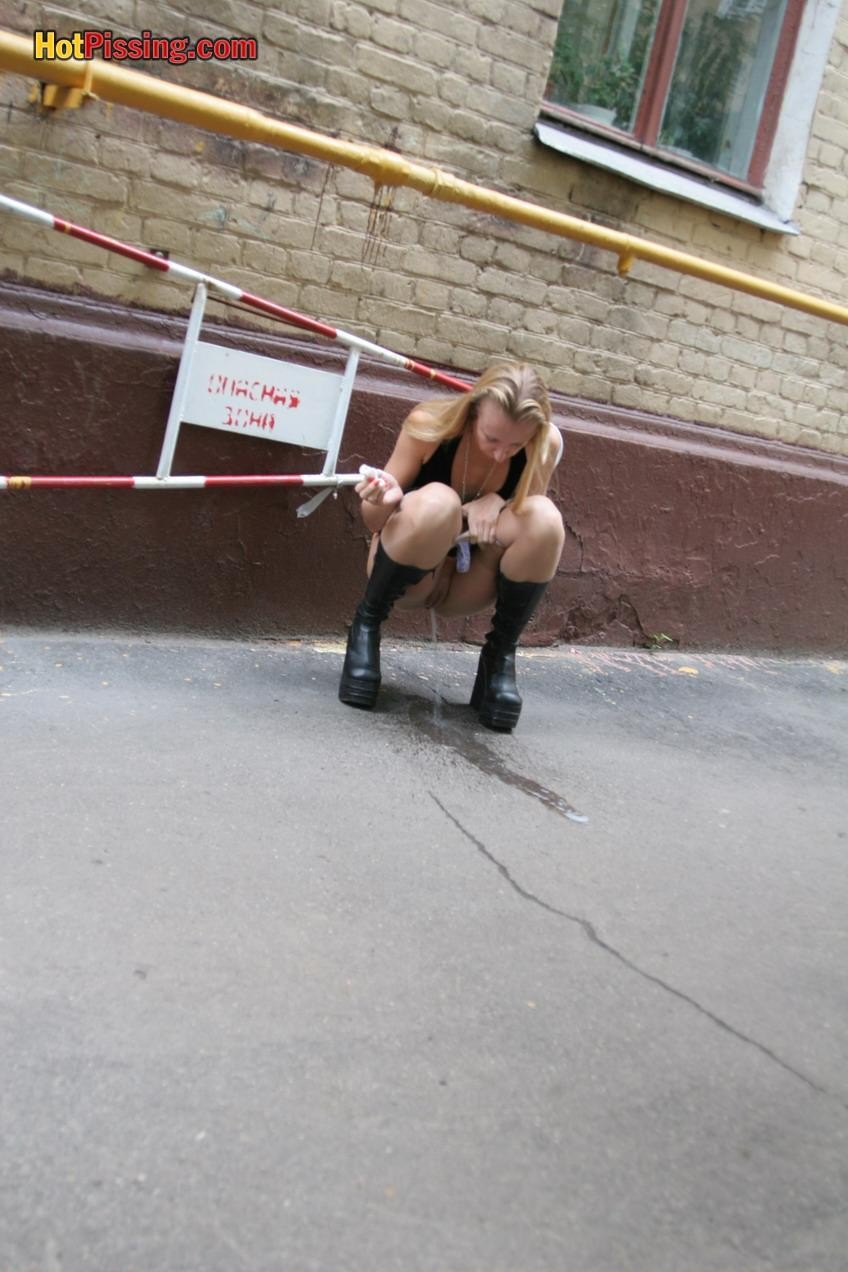 Gothic lady in black dress and platform boots does a pee in the street #76561302