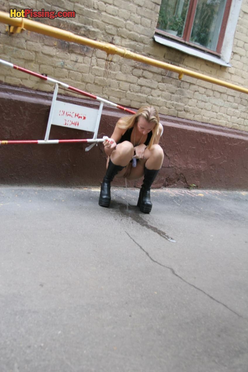 Gothic lady in black dress and platform boots does a pee in the street #76561312