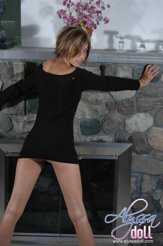 babe poses in a black dress and no panties by the fireplace #70631649