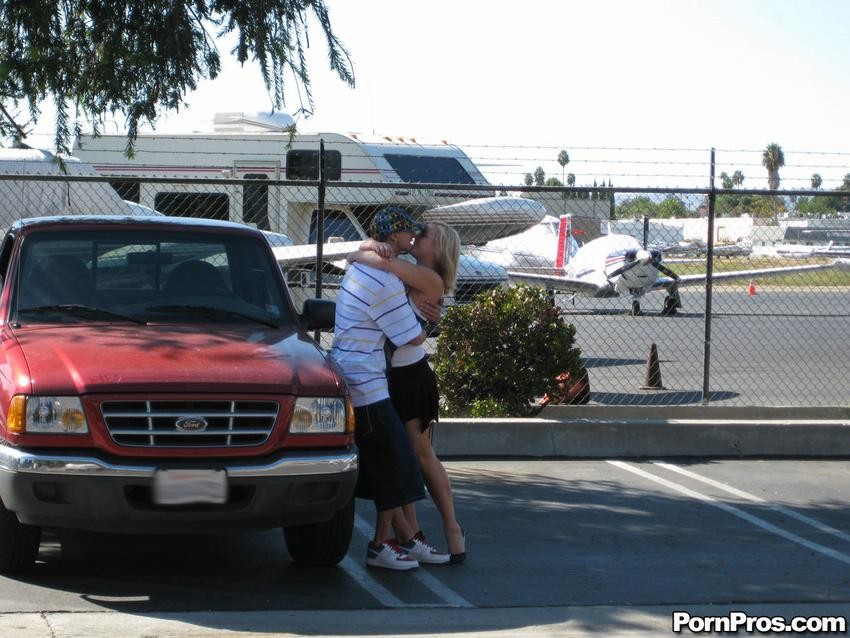 Chica rubia pillada besando a un tío en el parking
 #79368364