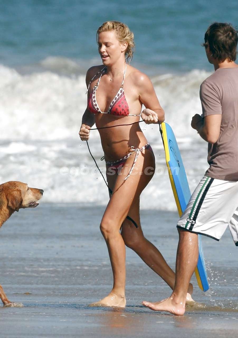Charlize Theron enjoy playing in bikini on beach paparazzi pictures #75297237