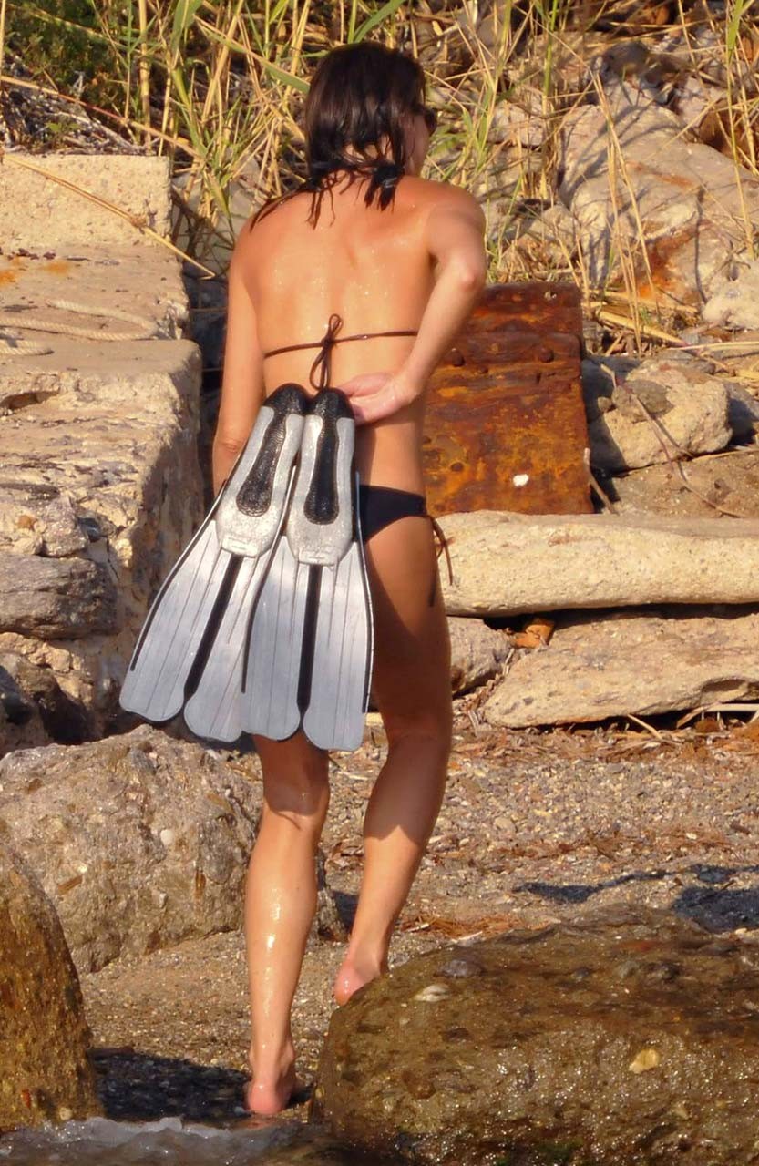 Carla Bruni showing her pookies in wet see thru bikini top on beach #75316648