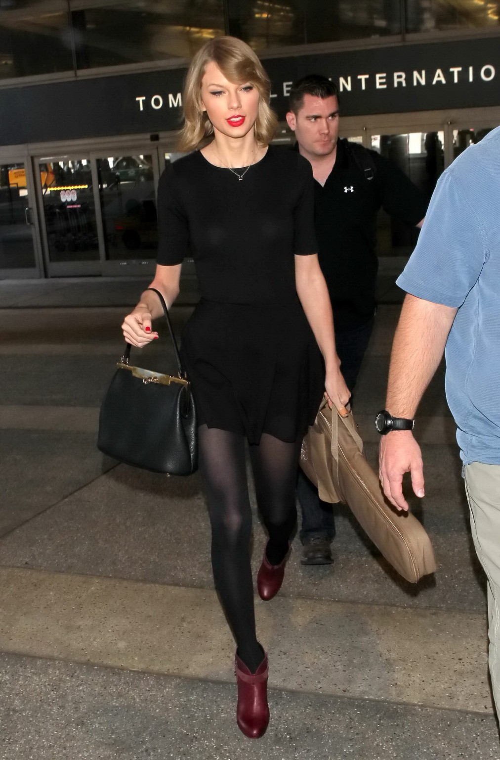 Taylor Swift leggy wearing black pantyhose  mini skirt at LAX airport #75204799
