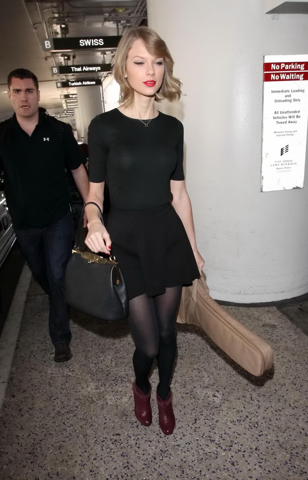 Taylor Swift leggy wearing black pantyhose  mini skirt at LAX airport #75204801