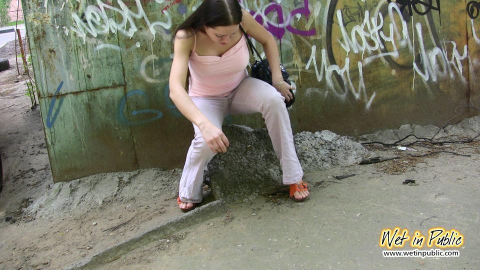 Longhaired amateur desperate to pee wets her pants and the asphalt #73239524