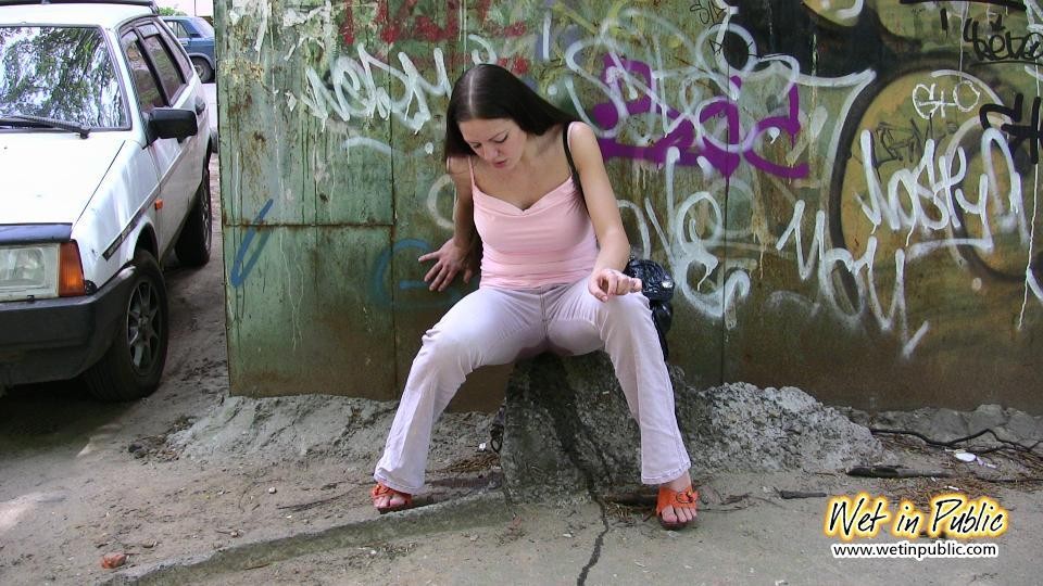 Longhaired amateur desperate to pee wets her pants and the asphalt #73239536