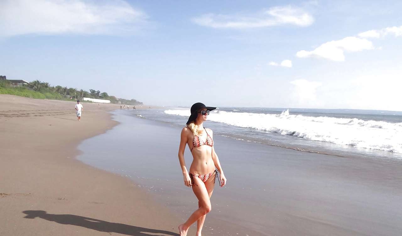 Paris Hilton in skimpy bikini and black hat on beach paparazzi pictures #75282013