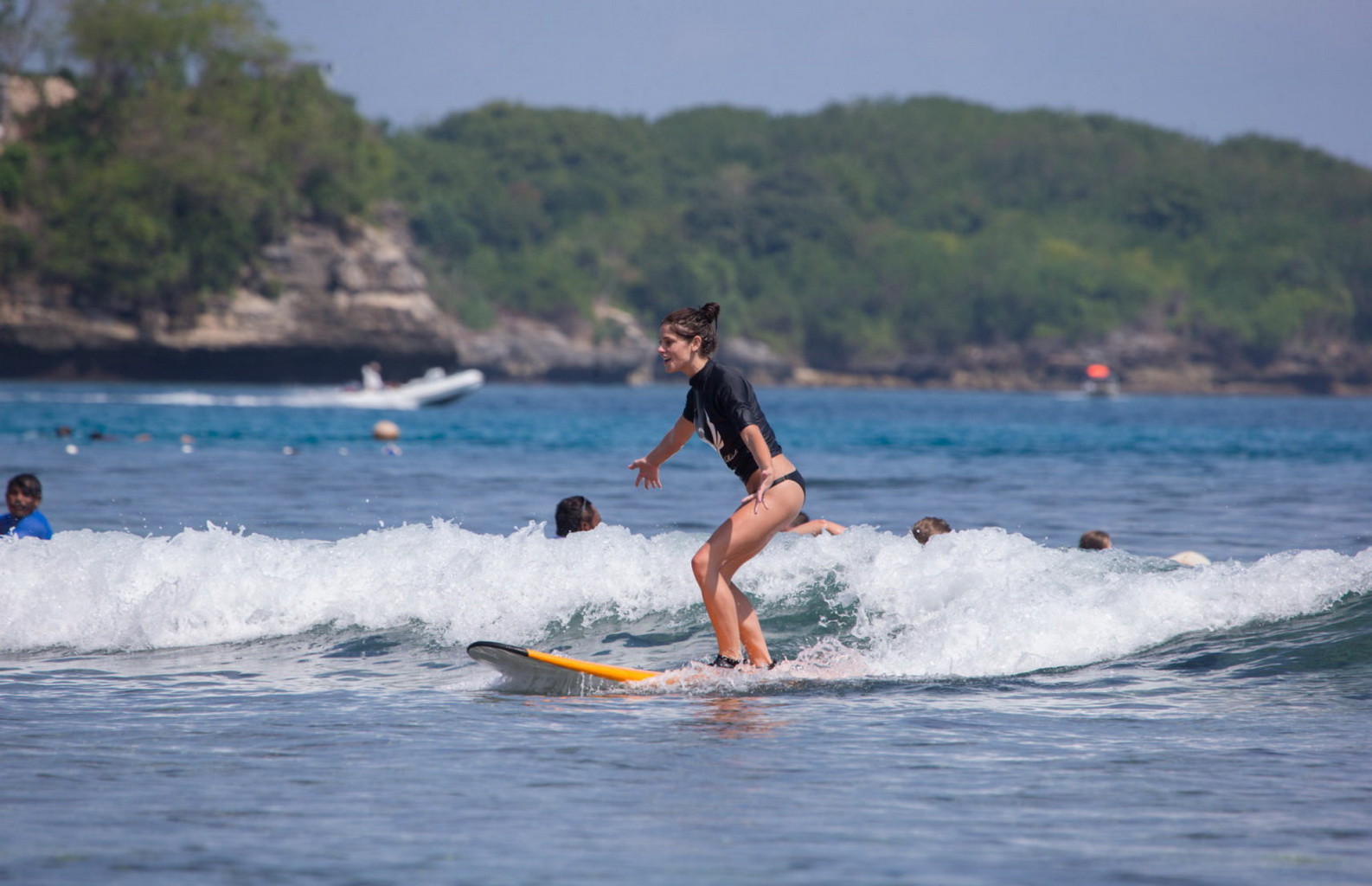 Ashley Greene wearing black bikini while surfing at the Oakley Learn To Surf Eve #75228284