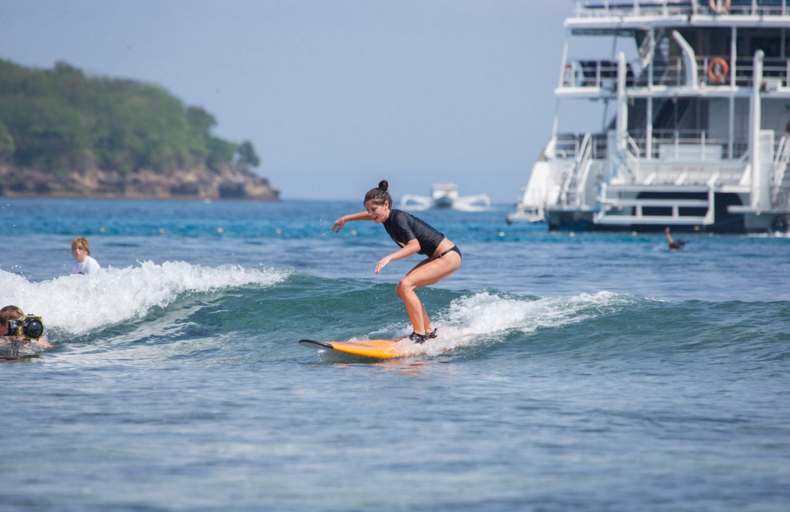 Ashley Greene wearing black bikini while surfing at the Oakley Learn To Surf Eve #75228292