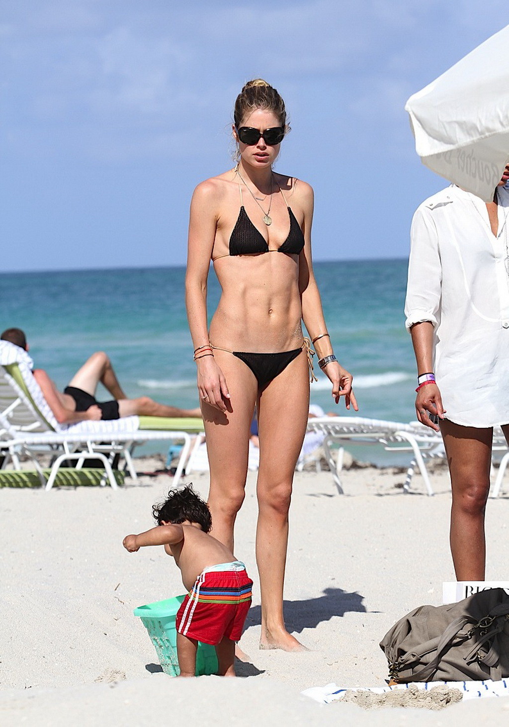 Doutzen Kroes walking in bikini top and shorts to the beach in Miami #75269139