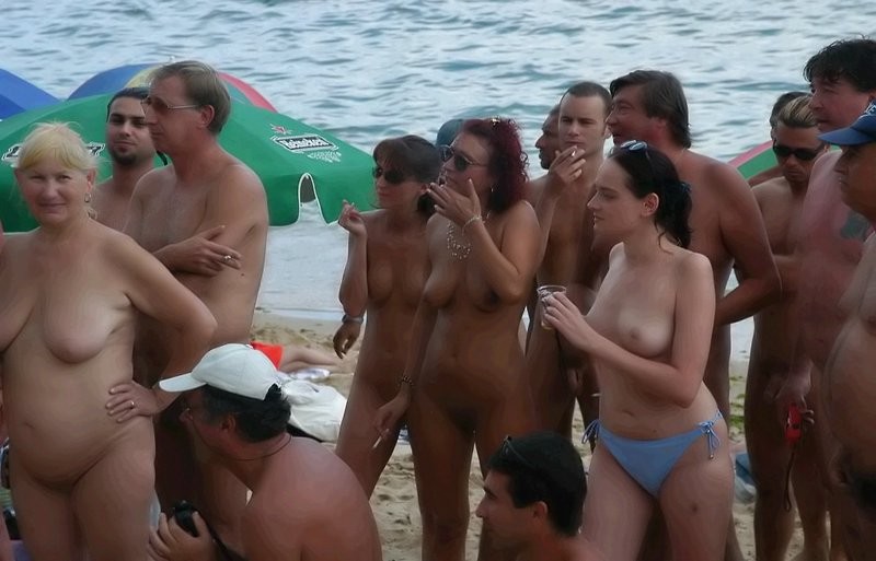 Nude people hanging out on the beach #78917412