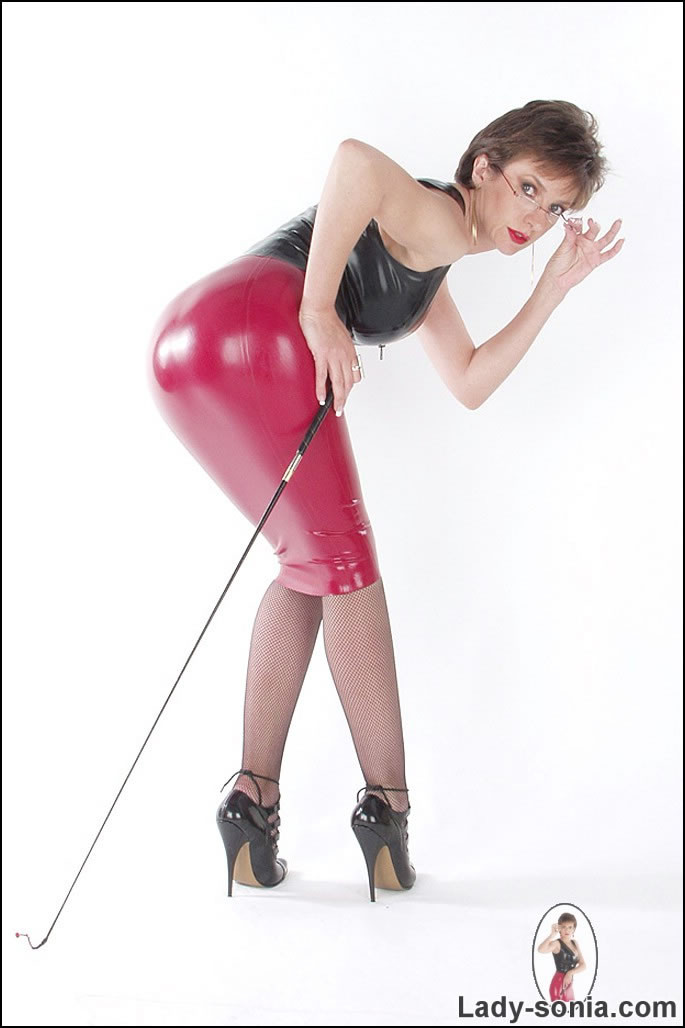 Rubber top and skirt beautiful dominatrix posing with a whip #72001908