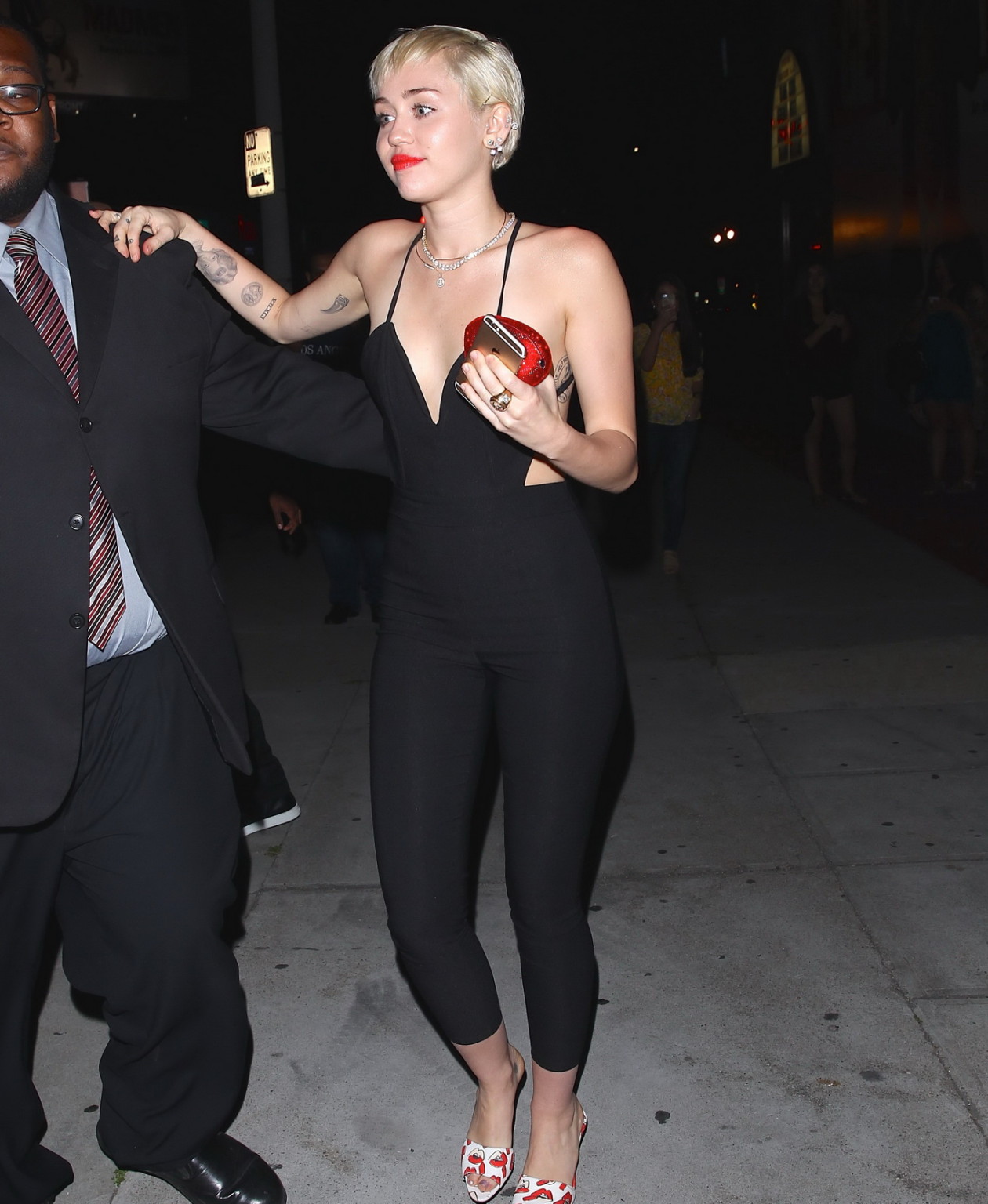 Miley Cyrus braless wearing tight black bareback jumpsuit night out in Los Angel #75169413