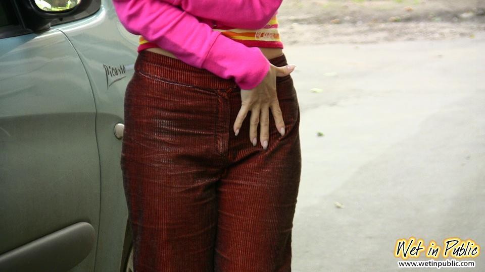 Nasty babe pee-soaks her sexy crimson pants behind a car in the yard #73244384