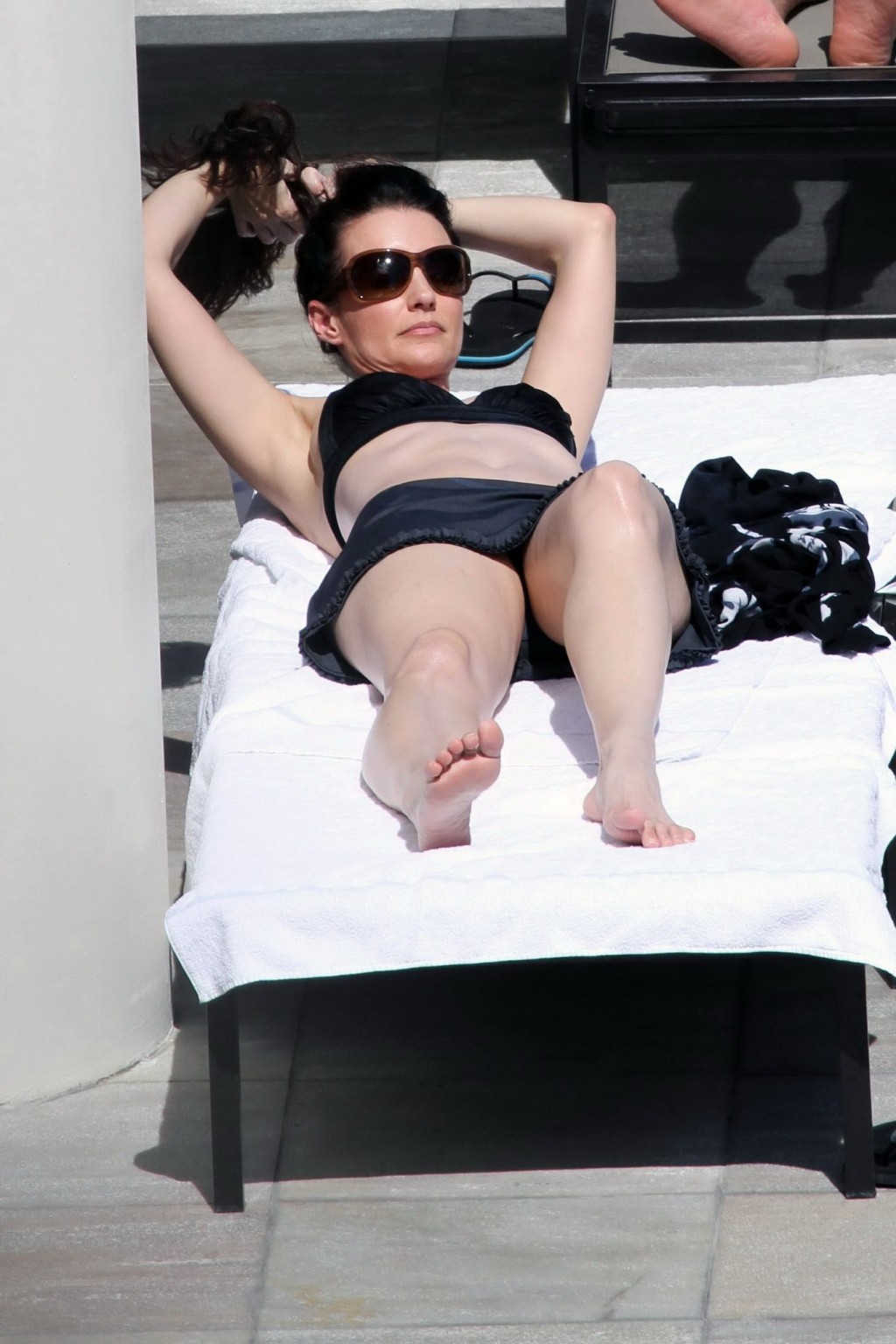 Kristin Davis in black bikini top  mini skirt tanning poolside in Hawaii #75328930