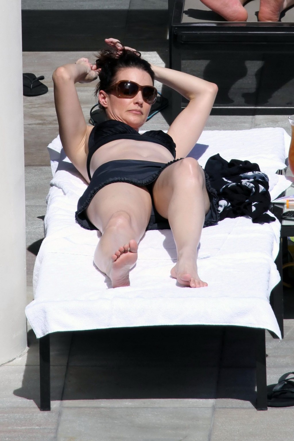 Kristin Davis in black bikini top  mini skirt tanning poolside in Hawaii #75328951