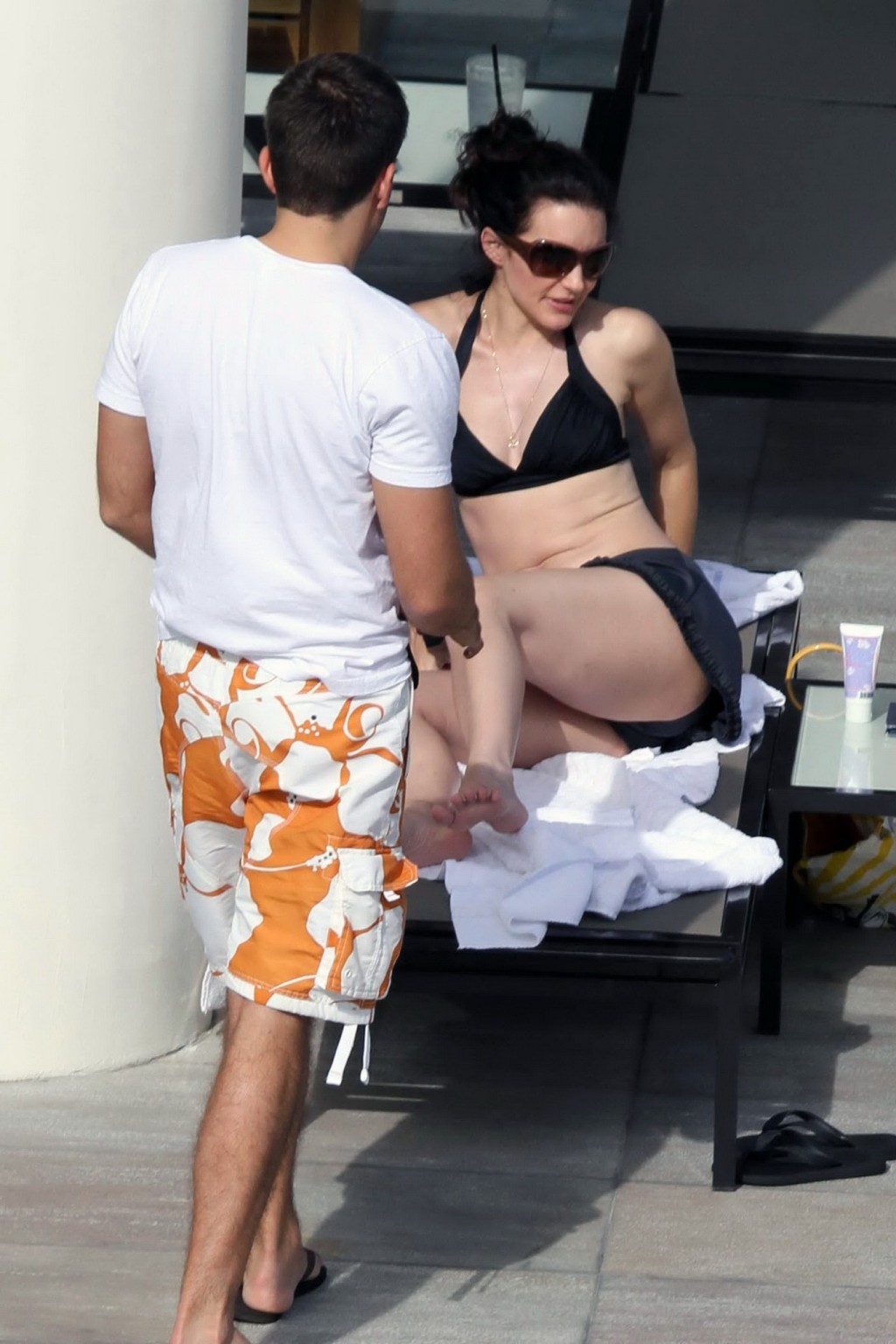 Kristin Davis in black bikini top  mini skirt tanning poolside in Hawaii #75329031