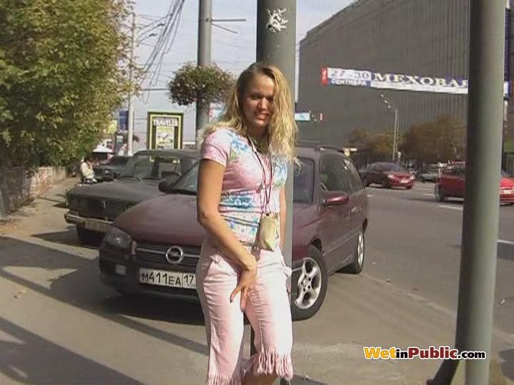 Curly blondie piddling in her sexy pink breeches right in the street #78595156