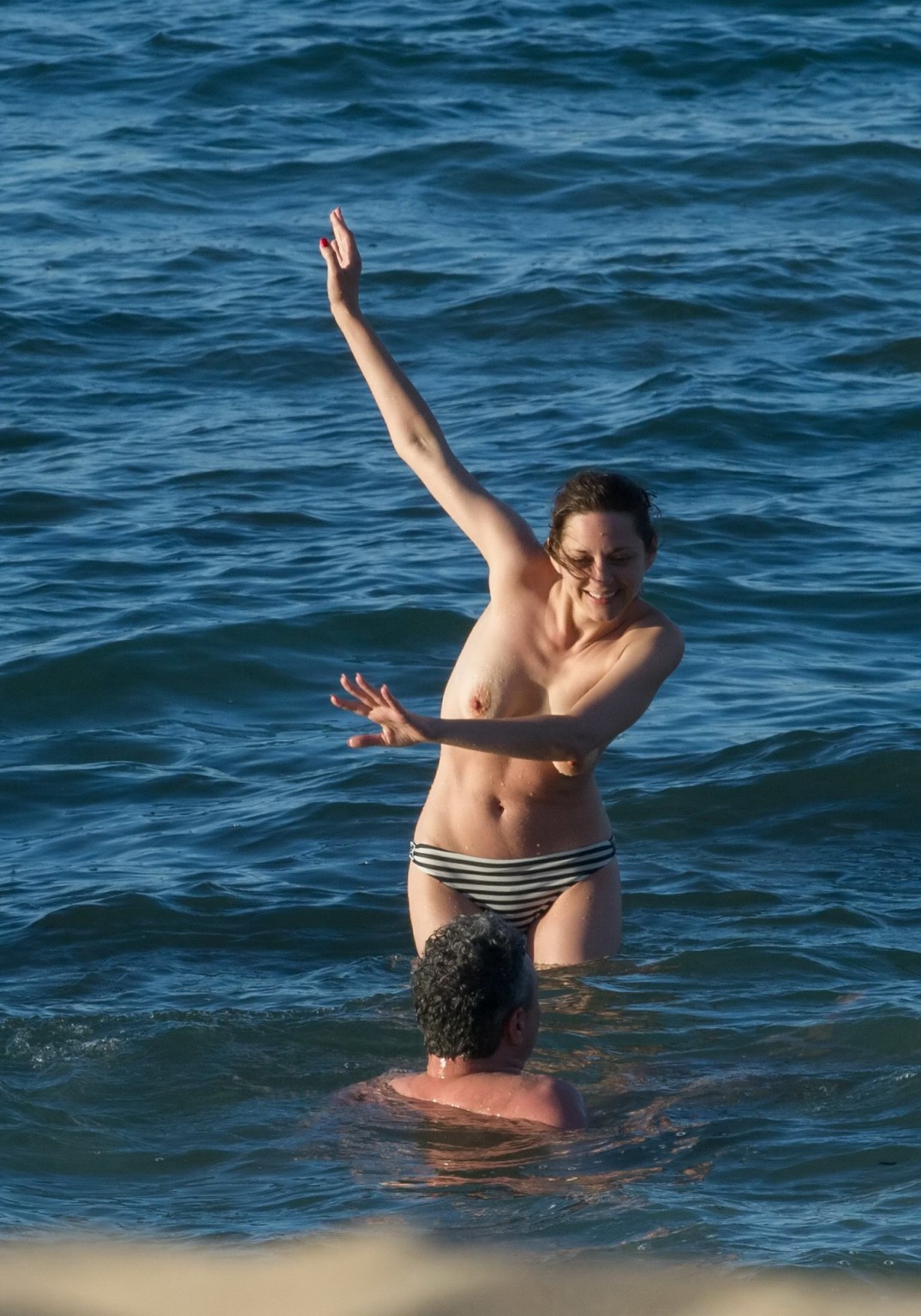 Marion Cotillard swimming topless at the beach #75141694