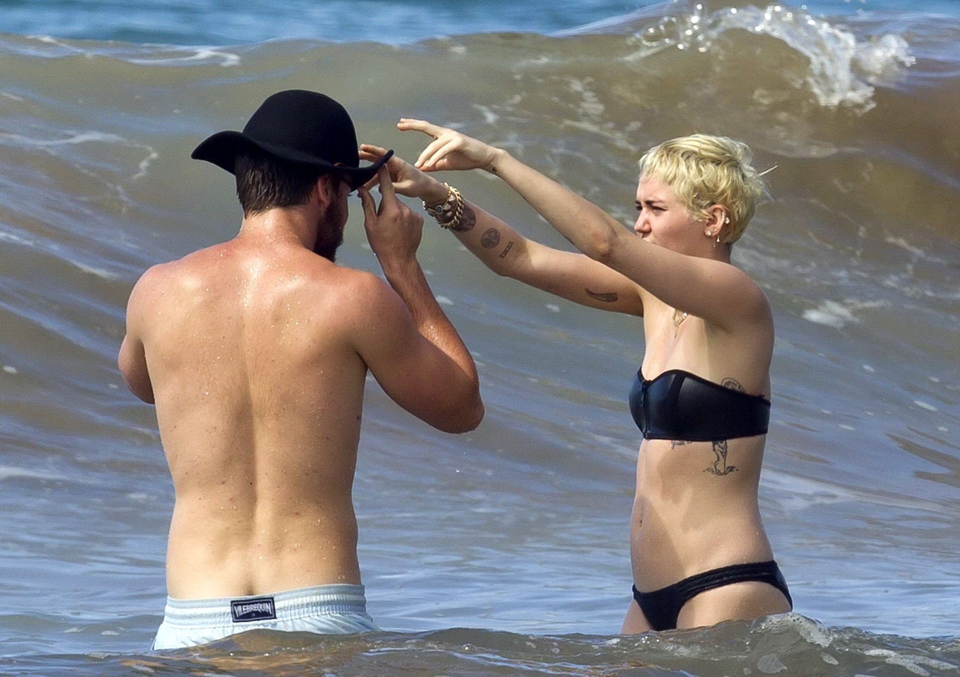 Miley Cyrus showing off her bikini body and getting her ass groped on a Hawaiian #75175236