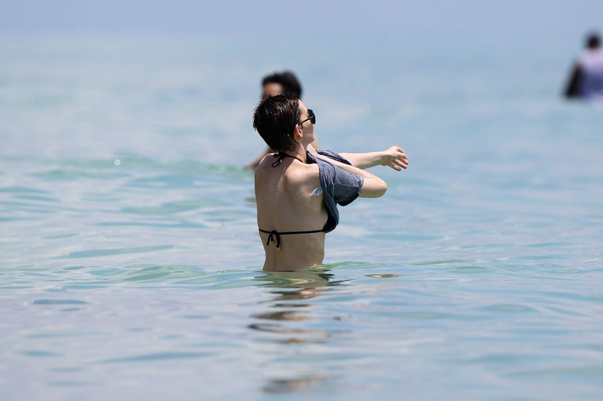 Anne Hathaway wearing a sexy black bikini on a beach in Miami #75263484