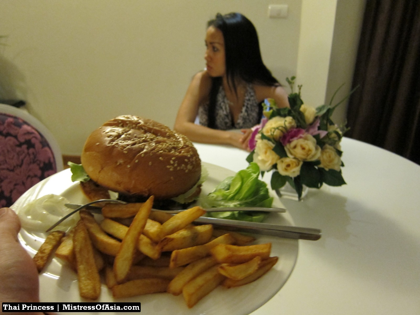 Thai Princess eating burger