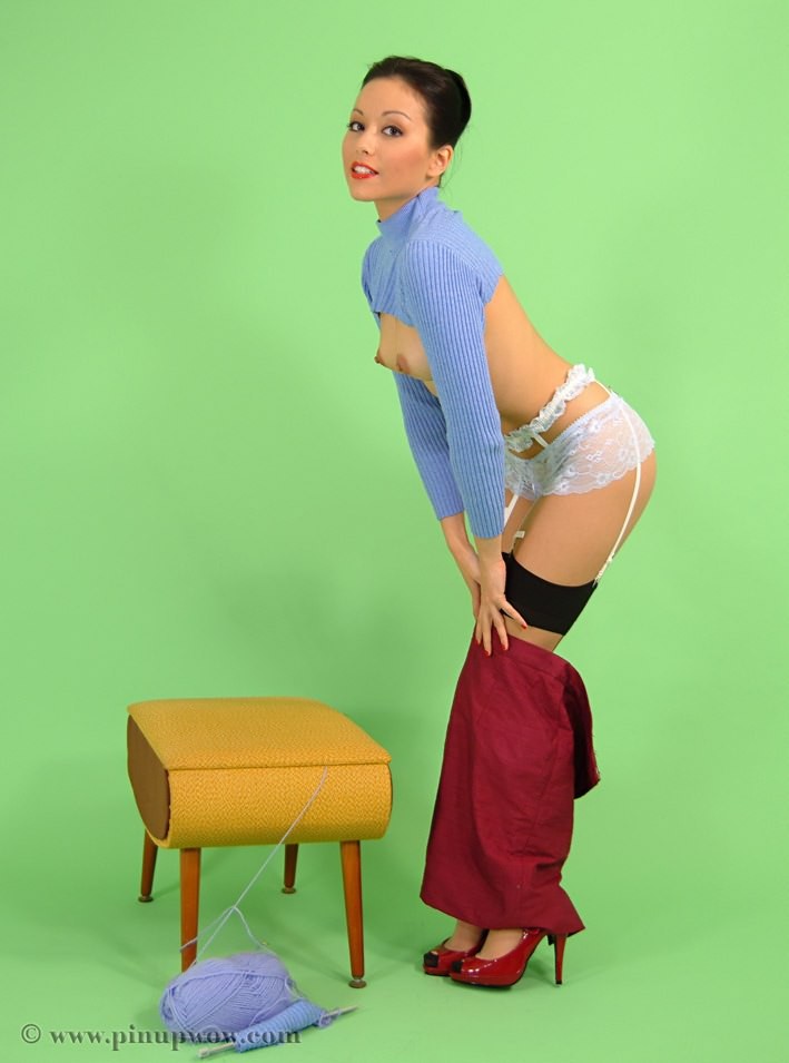 Sweet pinup girl in stockings doing handwork #72791701