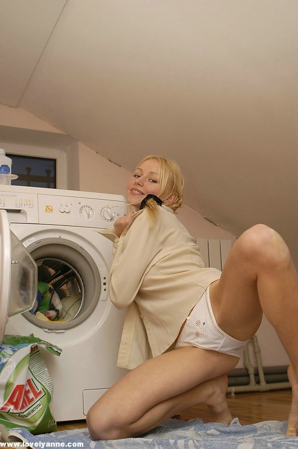 Teen strips near the washing machine #74037939