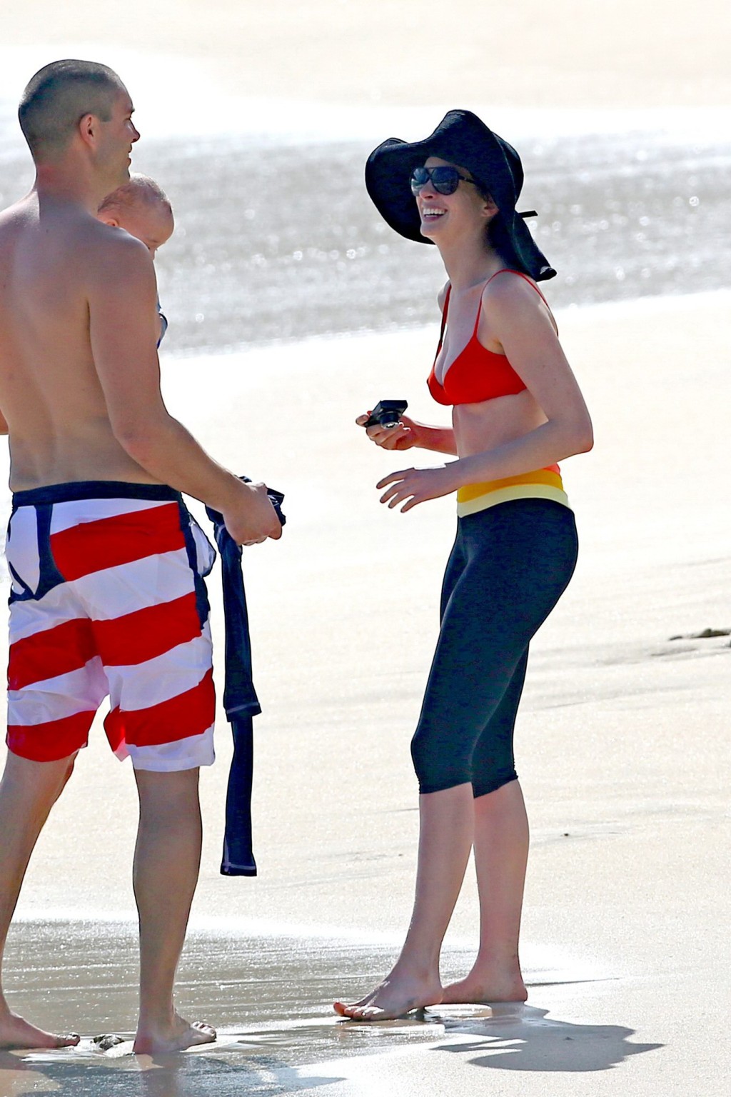 Anne Hathaway showing pokies in wet bikini tops on a Hawaiian beach #75207082