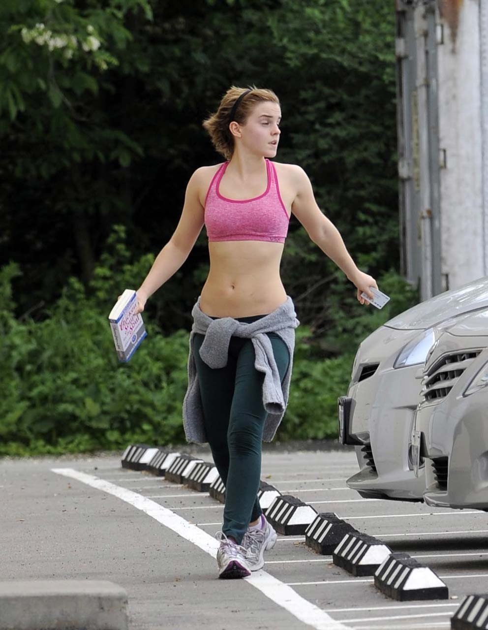 Emma Watson exposing sexy body and nice tits in sports bra on street #75302664
