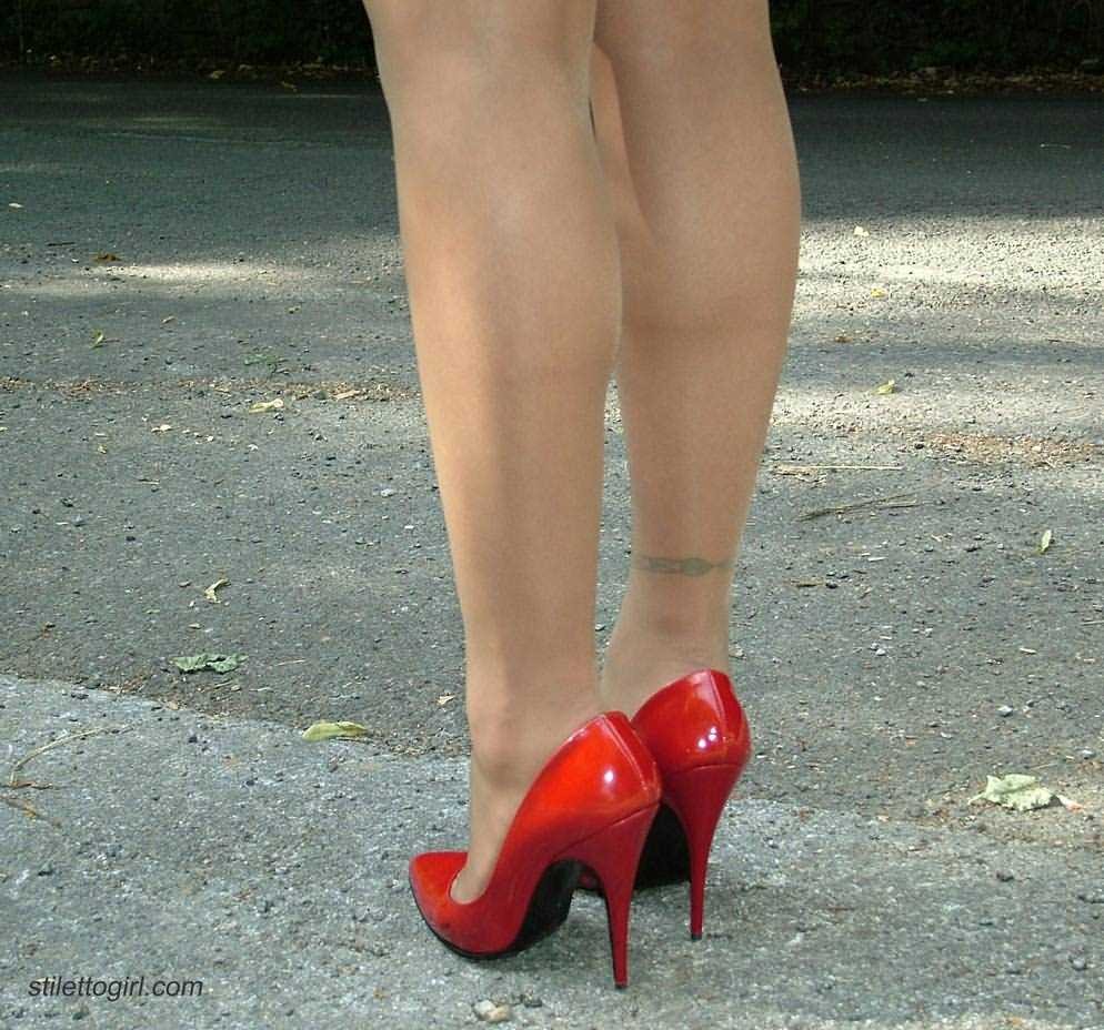 Stiletto girl in stockings and red high heels #72677333