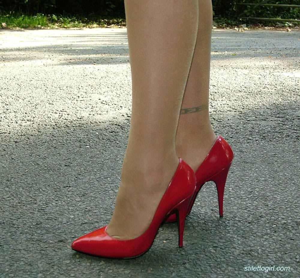 Stiletto girl in stockings and red high heels #72677364