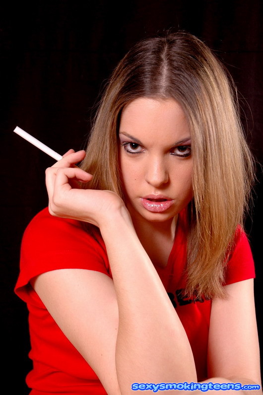 Cute innocent teen smokes a cigarette and plays with her pert  #70267561