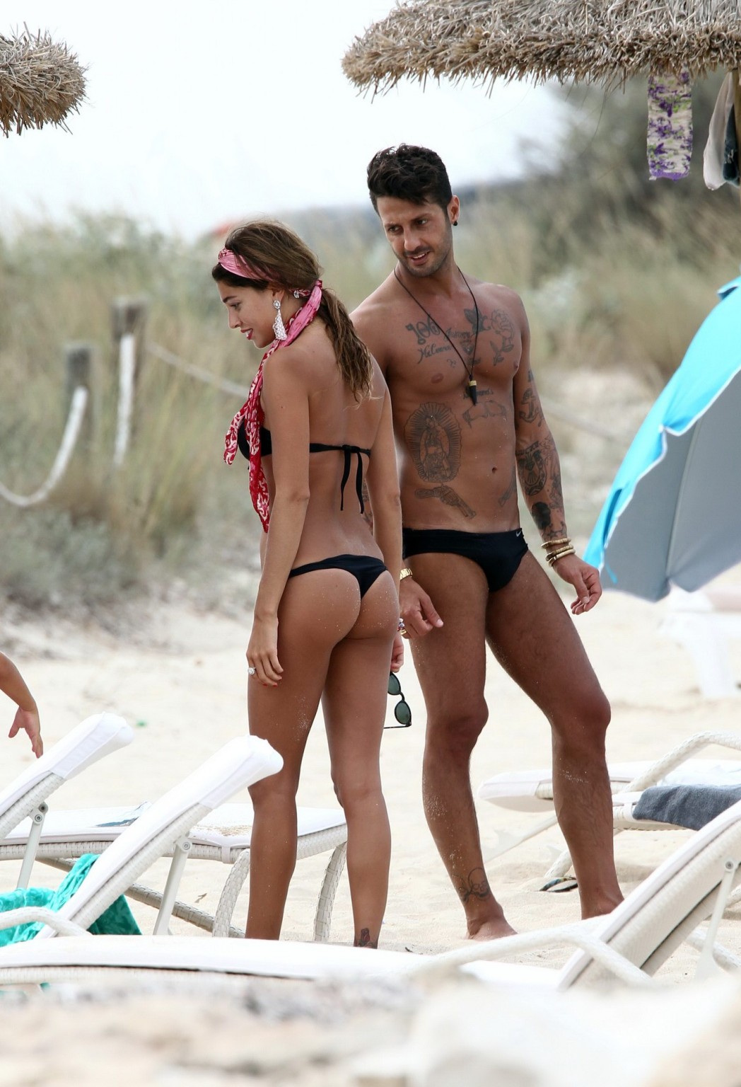 Belen Rodriguez shows off her ass wearing black thong bikini on the beach in For #75296183
