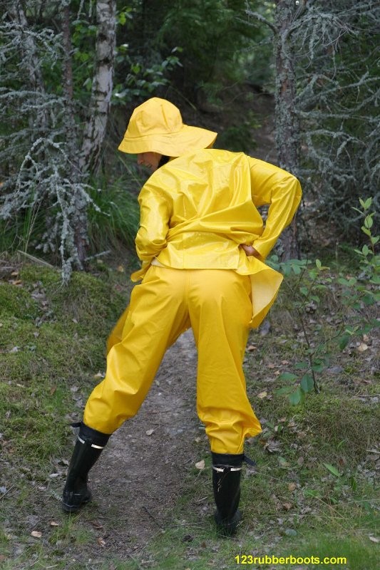 Sexy girl with rubber boots and yellow rainwear #73286050