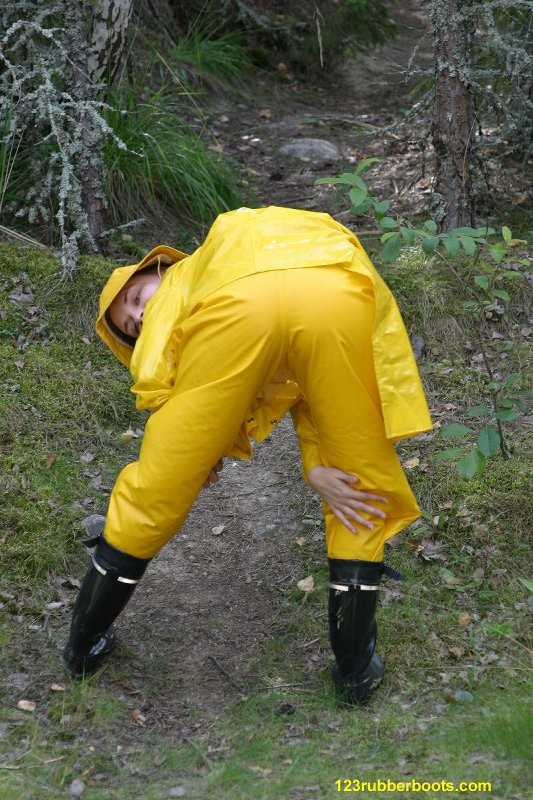 Sexy girl with rubber boots and yellow rainwear #73286057