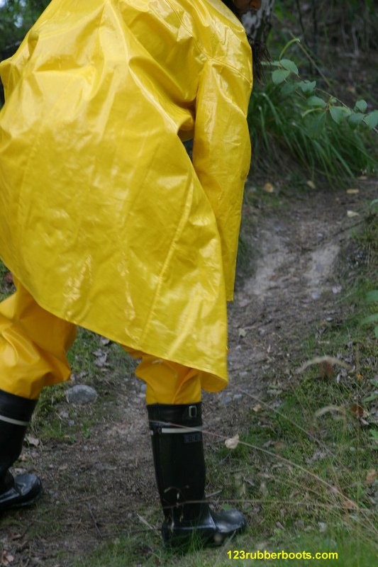 Sexy girl with rubber boots and yellow rainwear #73286064