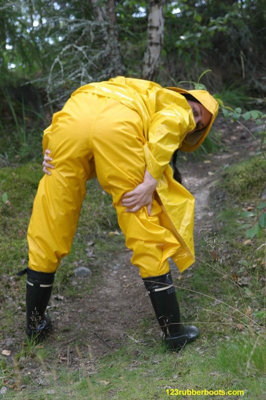 Sexy girl with rubber boots and yellow rainwear #73286089